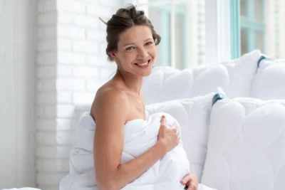 Kobieta owinięta kołdrą na lato