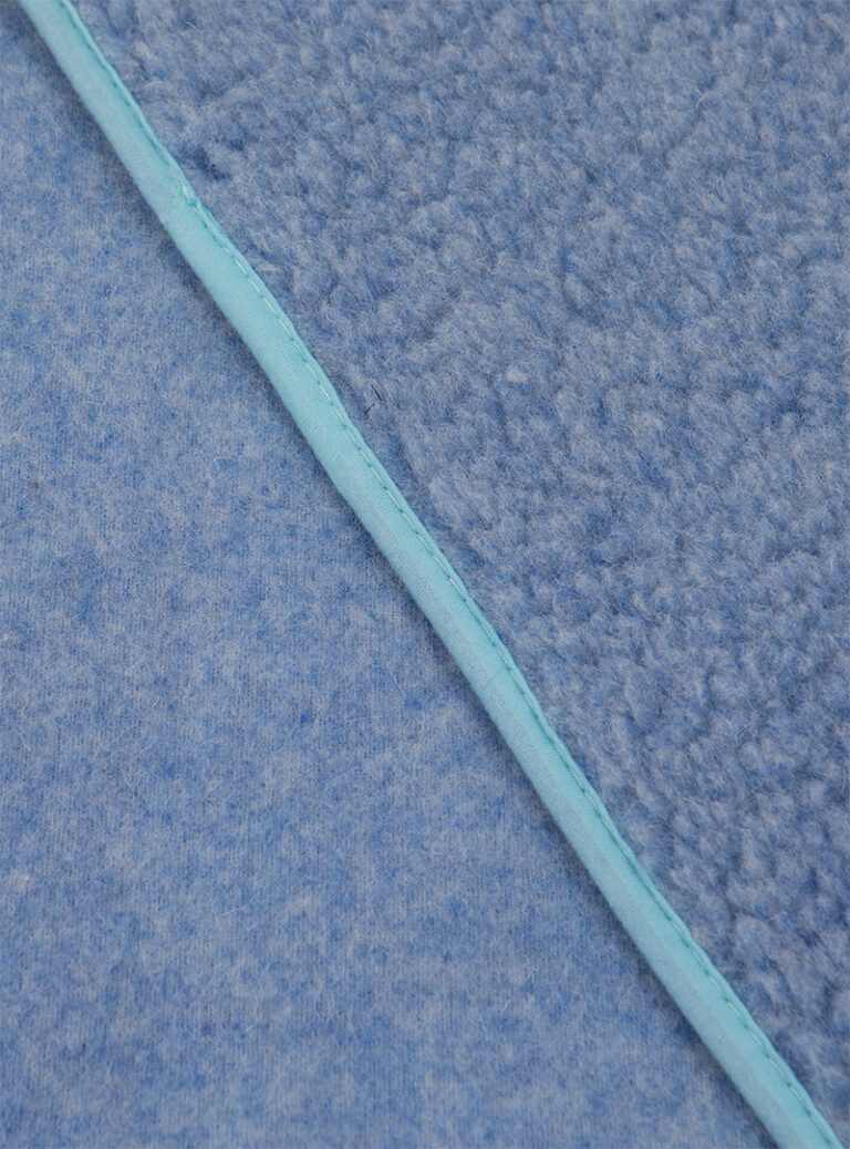 niebieski materiał z wełny z jasnoniebieskim wykończeniem