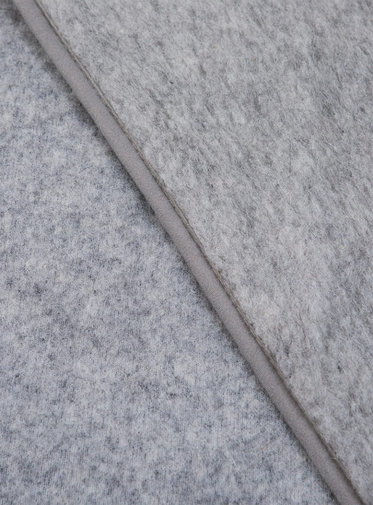 szary materiał wełniany z gładkim wykończeniem na neutralnym tle